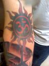 om and sun tattoo on arm